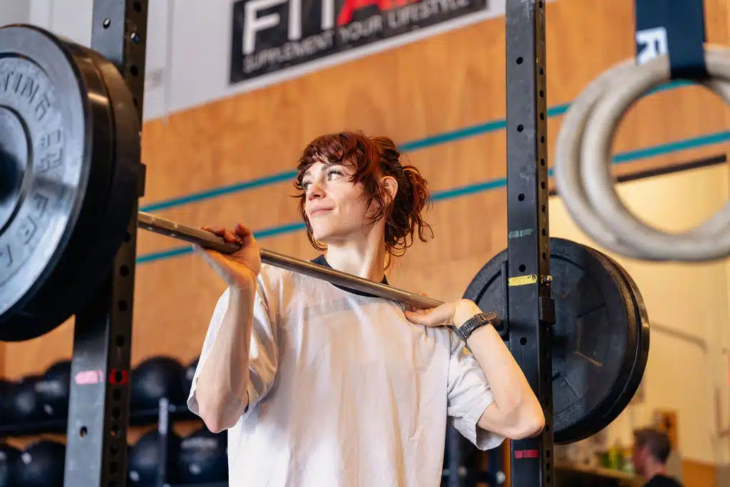Sarah holding a barbell during a training session